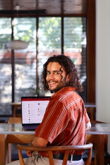 Jordan Sukhu, founder of Skytech Talent, working at a laptop